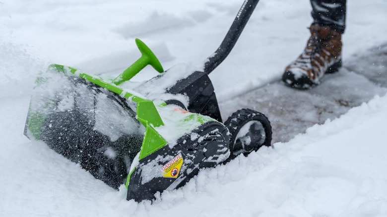 green Earthwise electric snow shovel on snow