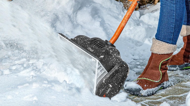 Person blowing snow with Litheli shovel