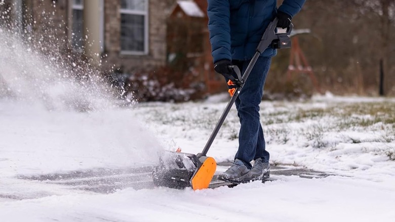 man using a cordless snow shovel