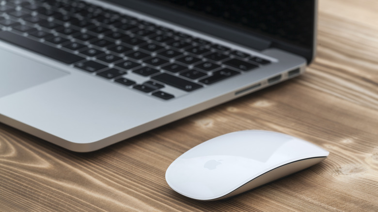 wireless mouse next to MacBook