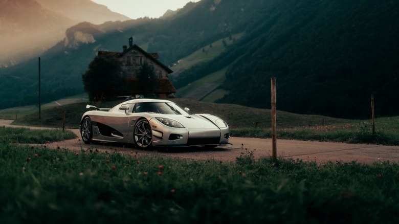 Gold Koenigsegg CCXR Trevita parked in front of an isolated house on a hillside