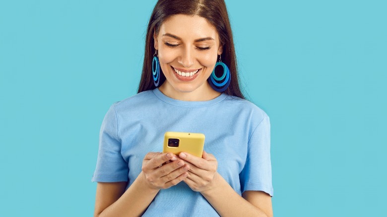 woman looking at mobile phone 