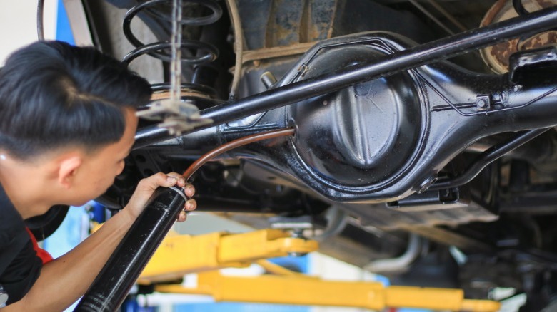 mechanic filling a differential