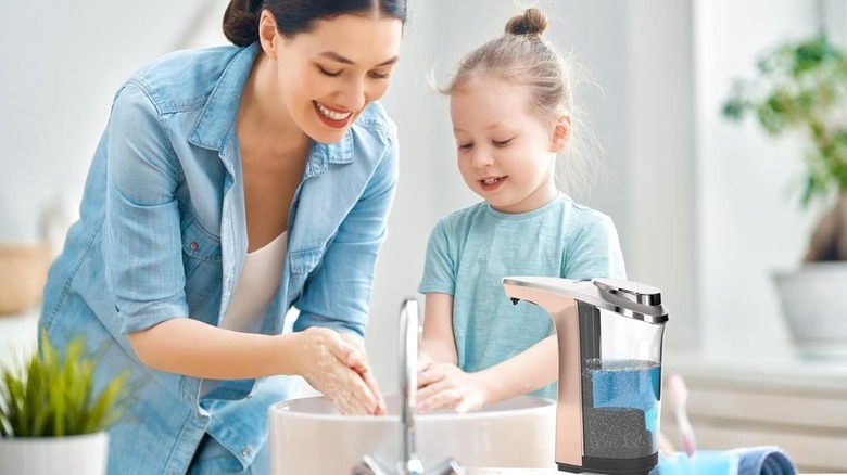 Mother and child washing hands