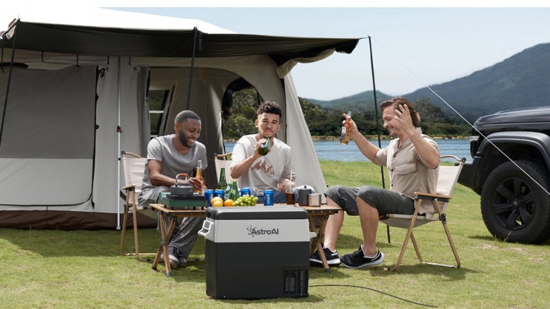 Three men around a table out drinking 