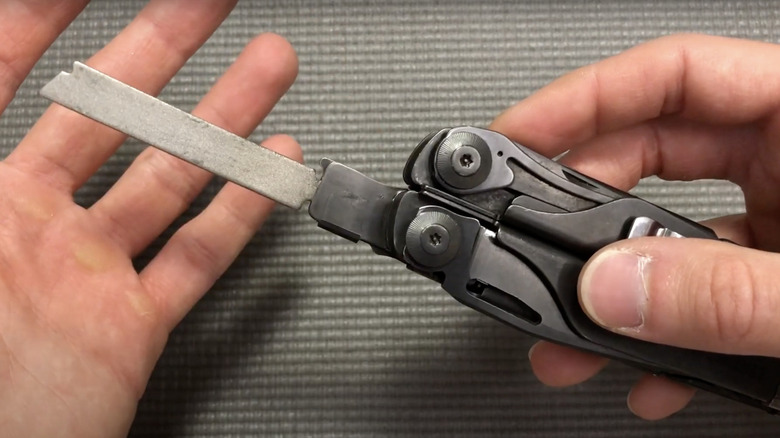 man showing off Leatherman multi-tool diamond file