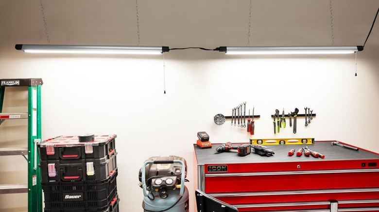 Braun hanging shop lights suspended over a DIY work space