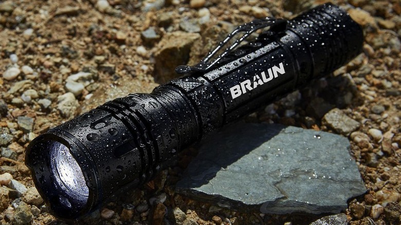 Braun flashlight looking under tire