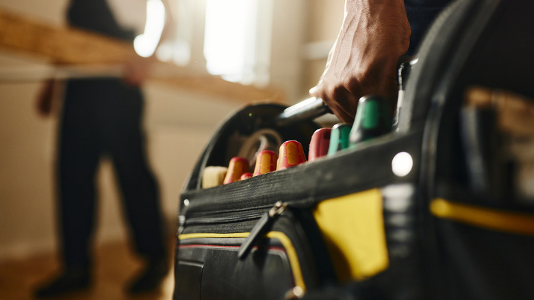 Carrying tool bag inside house