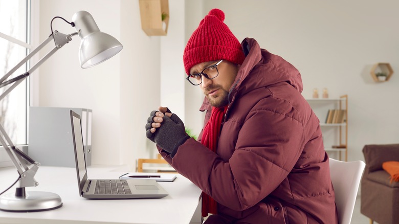 Man wearing winter outerwear in office setting