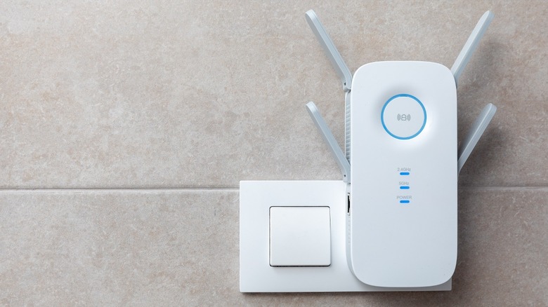 White Wi-Fi extender plugged in wall