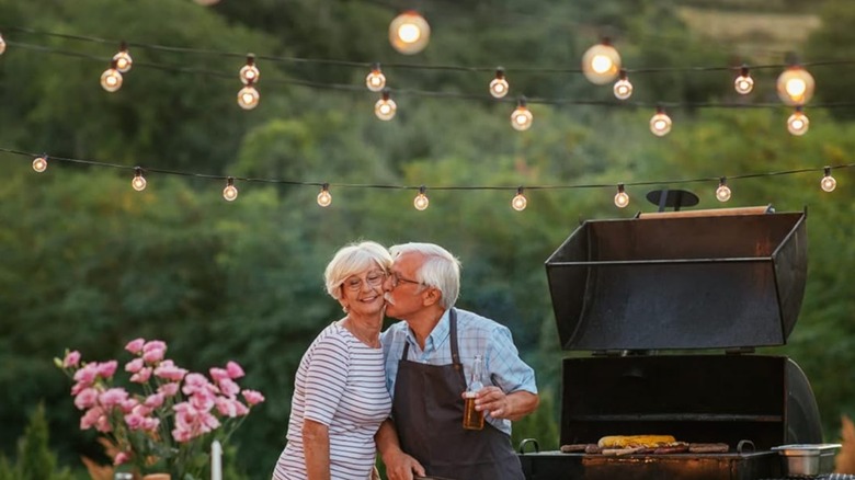 An image of a couple standing below Brightown outdoor string lights