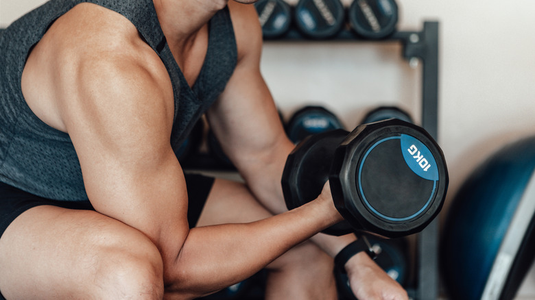 Close up of man lifting dumbell