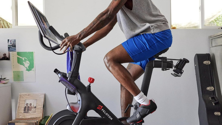 Man riding on Peloton bike in garage