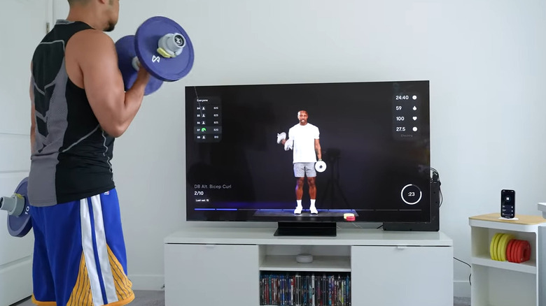 Man using Tempo Move workout while watching TV