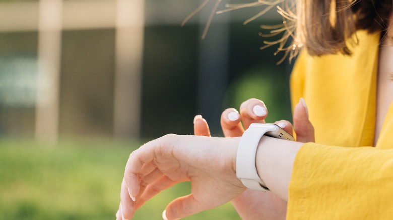 woman tapping Apple Watch