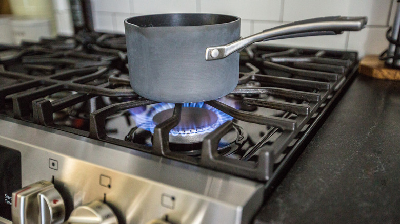 saucepan on an open gas flame burner