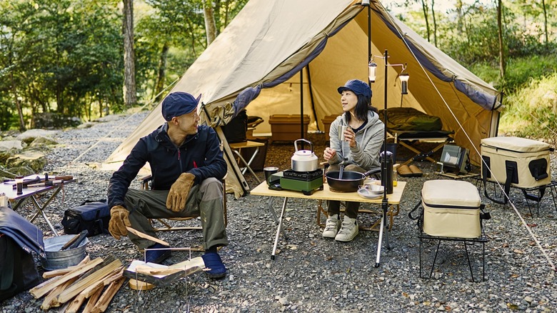 A couple camping outdoors