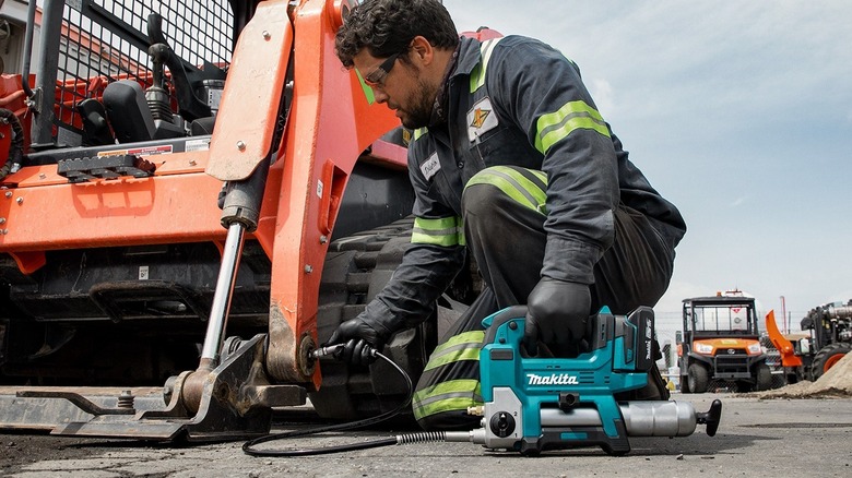 Man using Makita grease gun