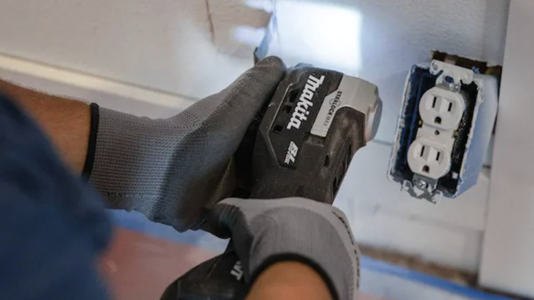 Makita multi-tool cutting into the wall