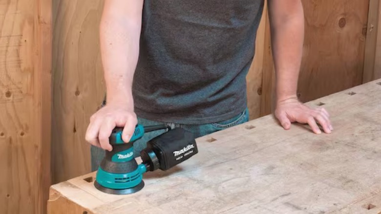 Person using circular saw on wood