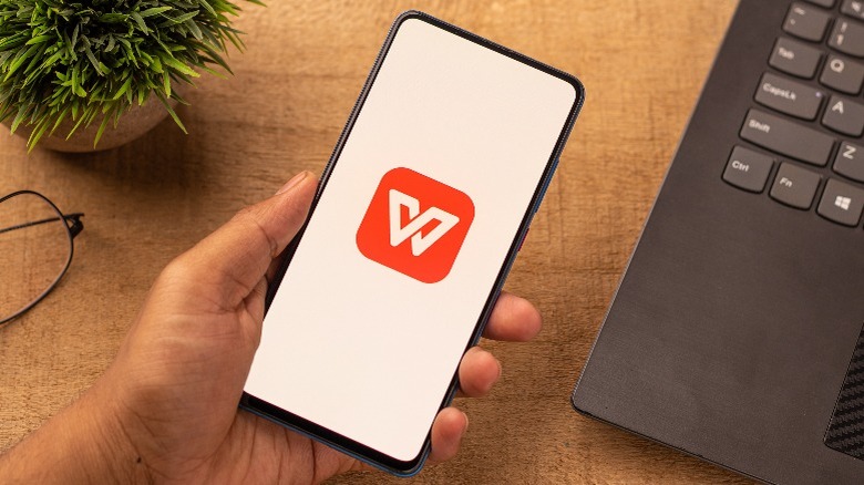 Person holding a phone with the WPS Office logo