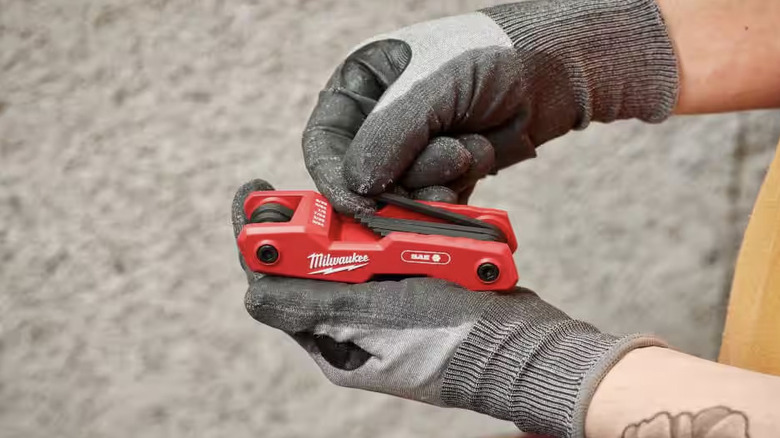 Person holding a Milwaukee hex key tool