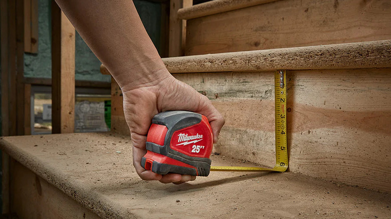 Man using tape measure to measure steps