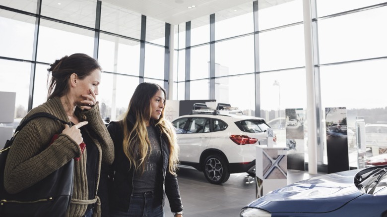 A person car shopping with a friend