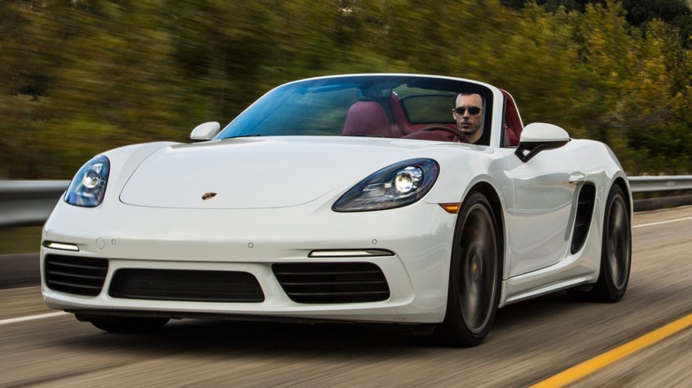 a white Porsche 718 Boxster S driving down the freeway