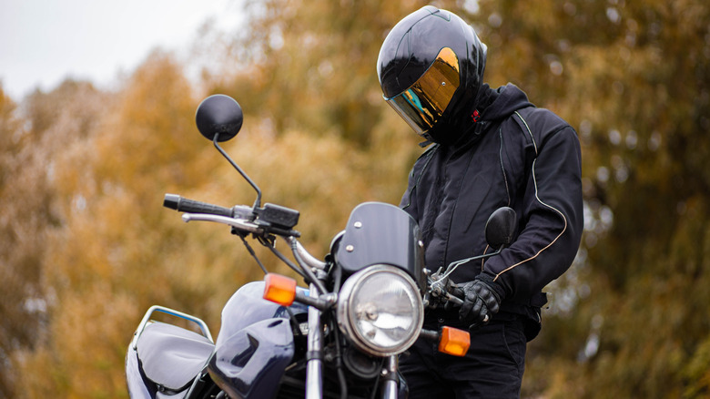 A rider with a motorcycle jacket on