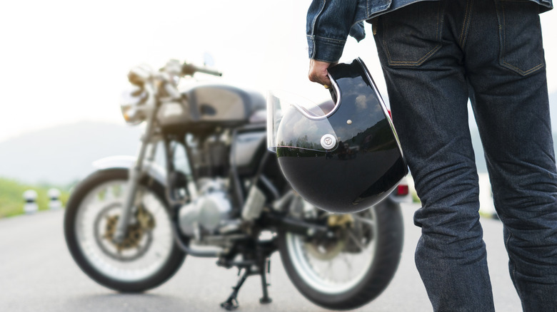 A biker in protective riding pants and boots