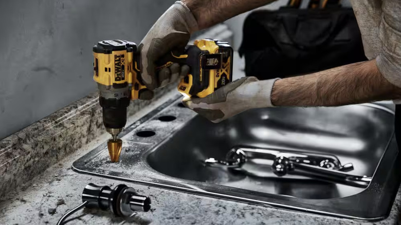 DeWalt drill driving holes in sink