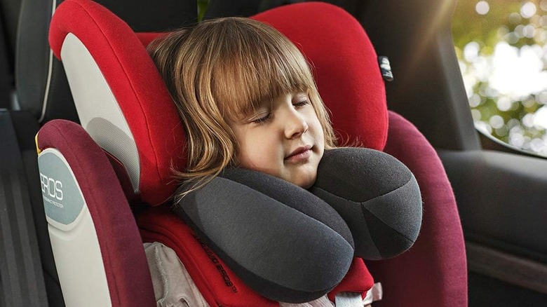 child sleeping with travel pillow