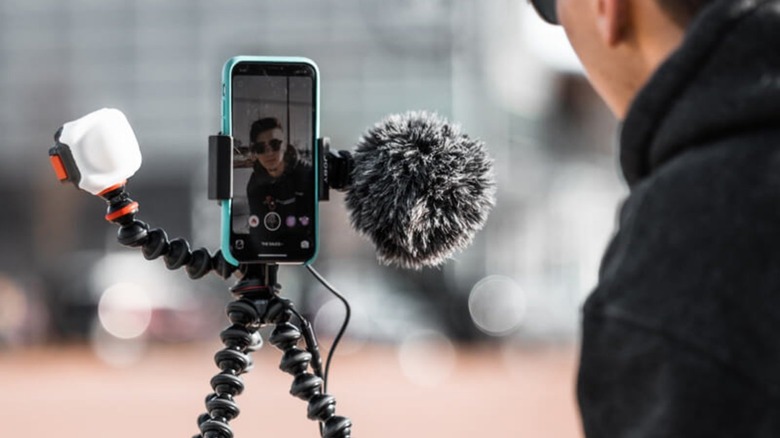 Man using phone to film himself