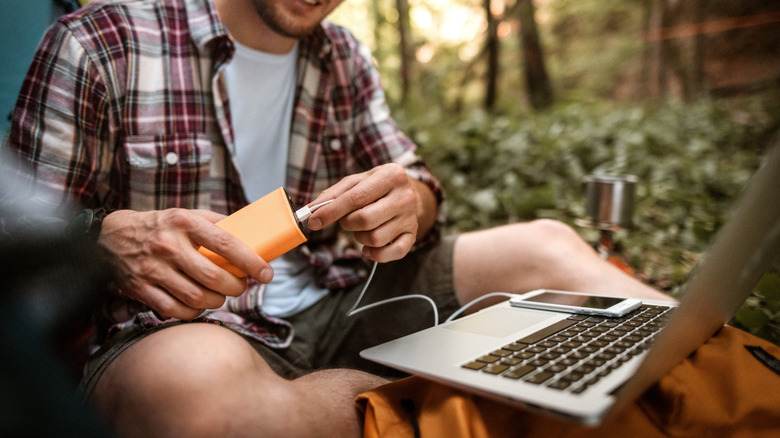 person plugging in portable charger