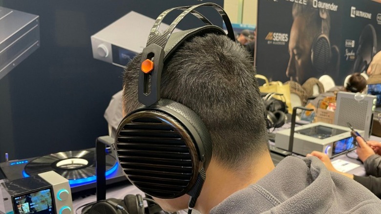 Person wearing FiiO FT7 Planar Magnetic Headphones at convention