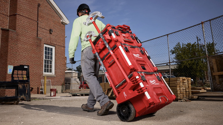 Worker pulling Packout Stack wit Long Tool Holder Attachment and tools