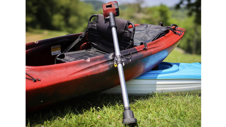 Fordwalt Cordless Stick Water Transfer Pump resting against a kayak