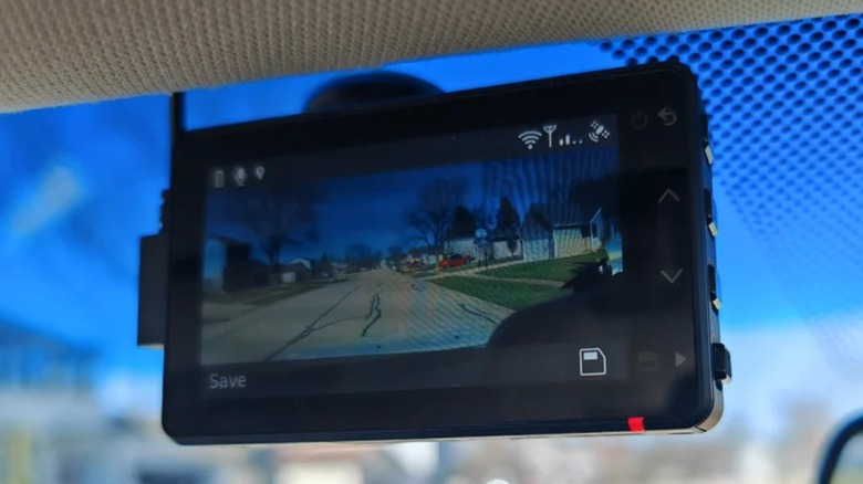 A garmin dash cam mounted on a car windshield