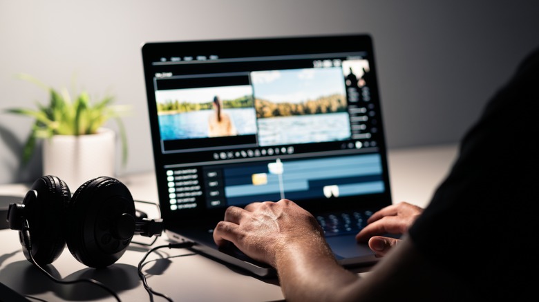 Person editing video on laptop