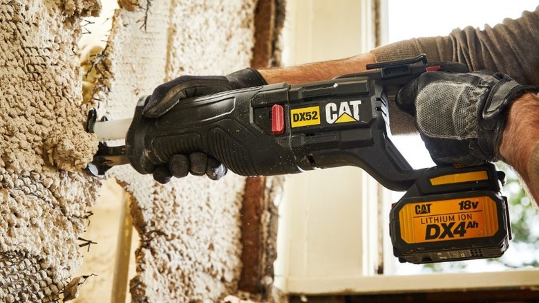 person using Cat 18V Cordless Reciprocating Saw