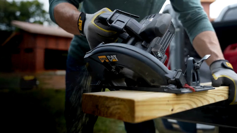 man using Cat 15A 7.25-inch Corded Circular Saw