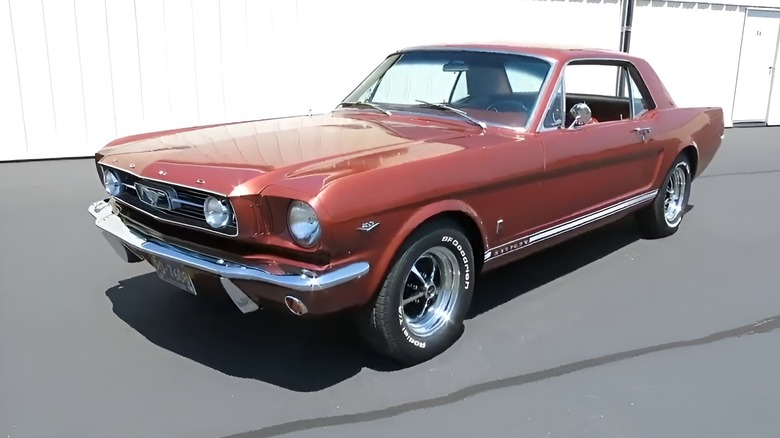 Emberglo Mustang parked next to building