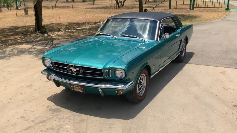 Turquoise Mustang on driveway