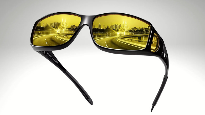 Urumqi yellow-tinted anti-glare glasses featuring a superimposed image of a city street on the lenses