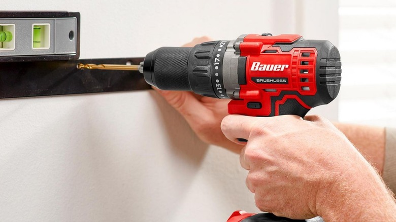 A person using a Bauer cordless drill