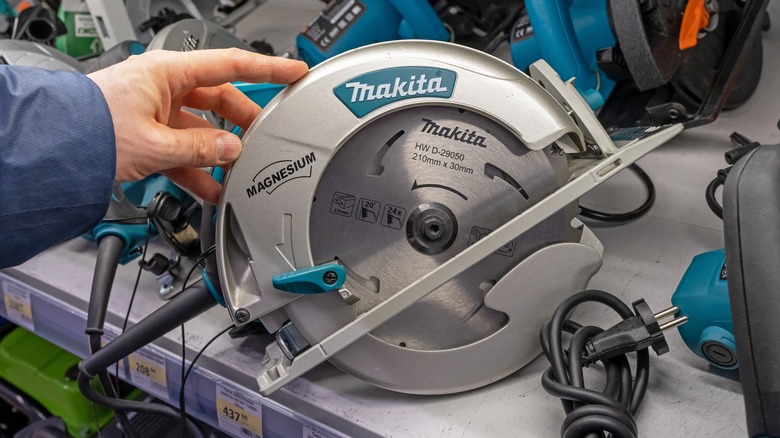 Person inspecting a Makita saw