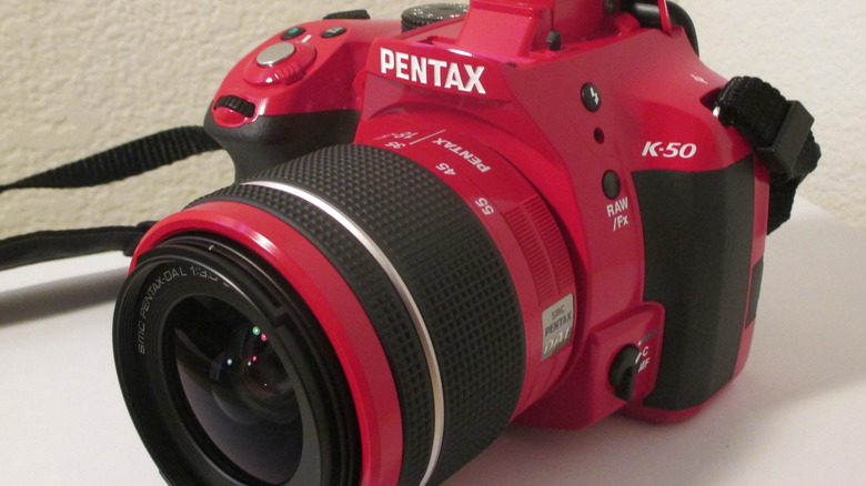 A red Pentax K-50 camera