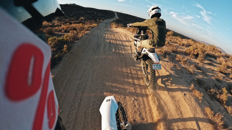 Action Cam POV from a helmet with another dirt bike riding ahead